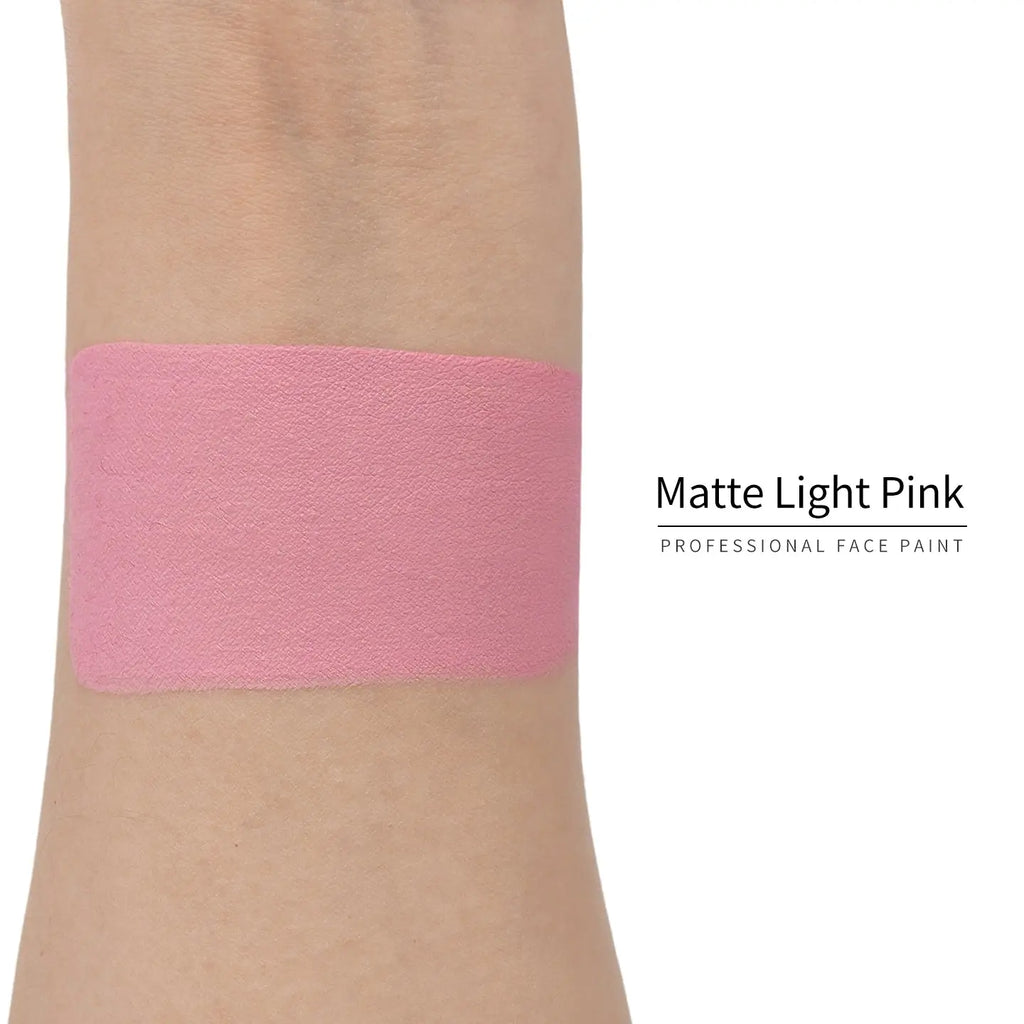 Matte light pink face paint swatch on arm, high pigment water based body art makeup