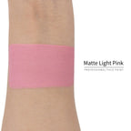 Matte light pink face paint swatch on arm, high pigment water based body art makeup