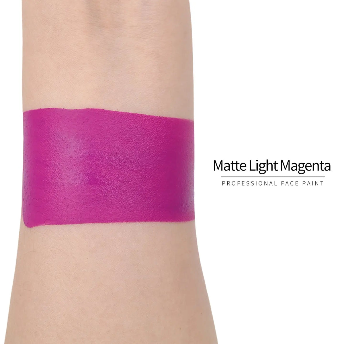 Matte light magenta face paint swatch on arm, high pigment water based body art makeup
