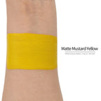 Matte mustard yellow face paint swatch on arm, high pigment water based body art makeup