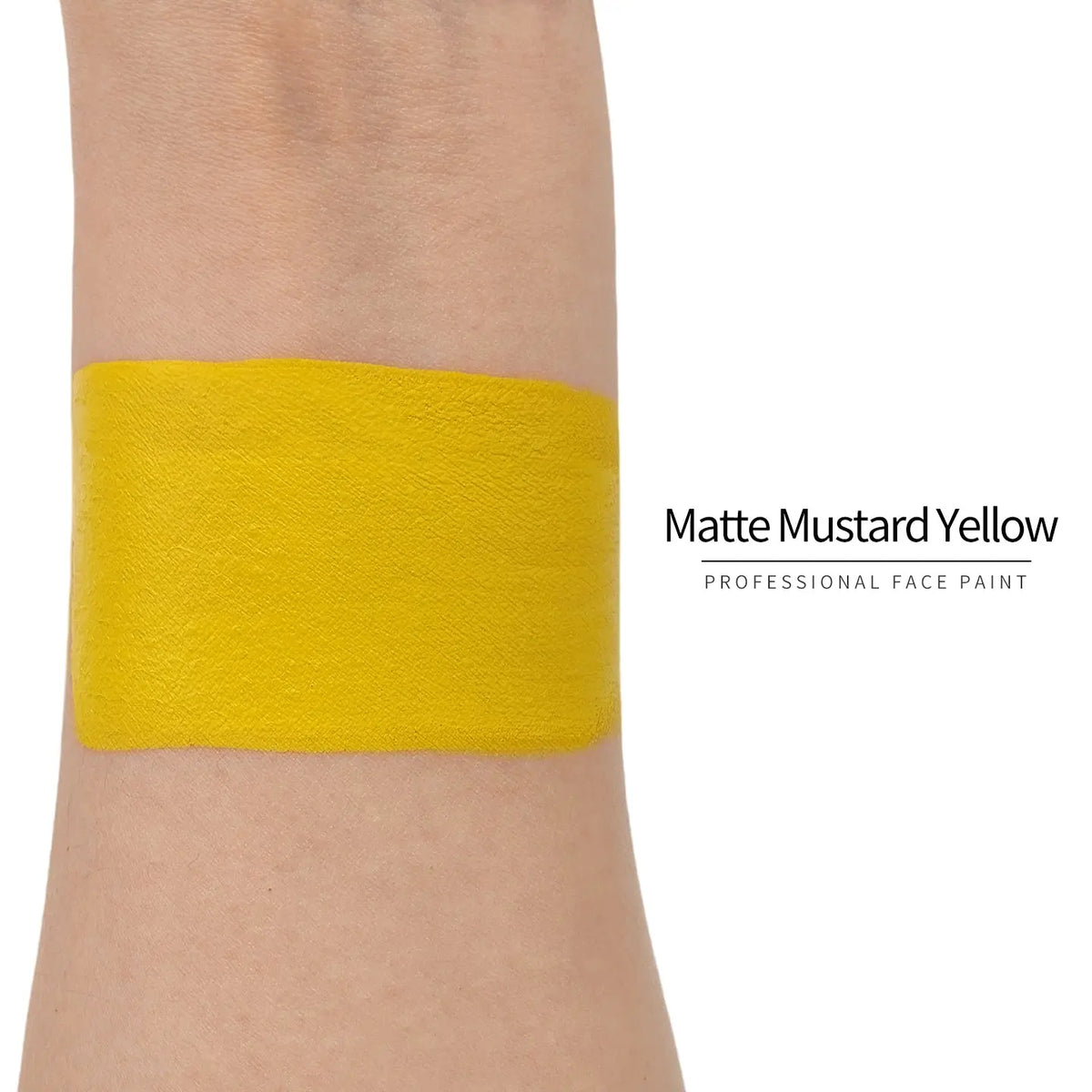 Matte mustard yellow face paint swatch on arm, high pigment water based body art makeup