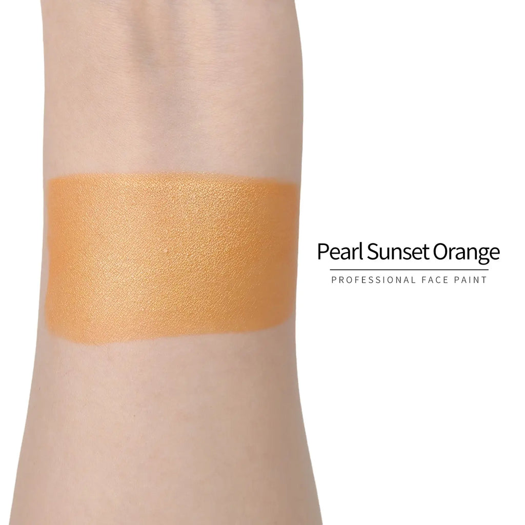 Anka Bella Pearl Sunset‑Orange face paint arm swatch, warm shimmer sunset‑orange pearl body paint sample on skin