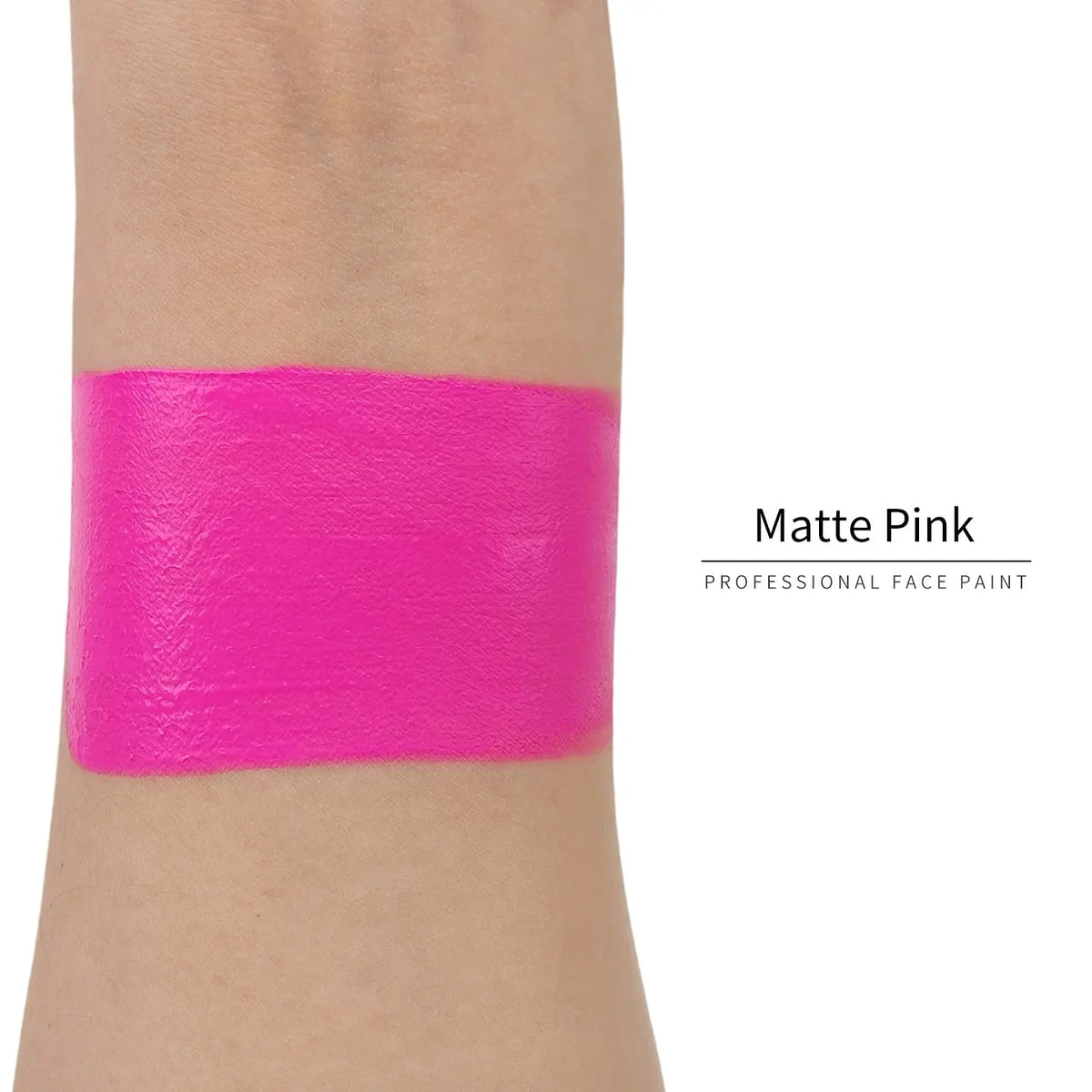 Matte pink face paint swatch on arm, high pigment water based body art makeup
