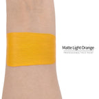 Matte light orange face paint swatch on arm, high pigment water based body art makeup