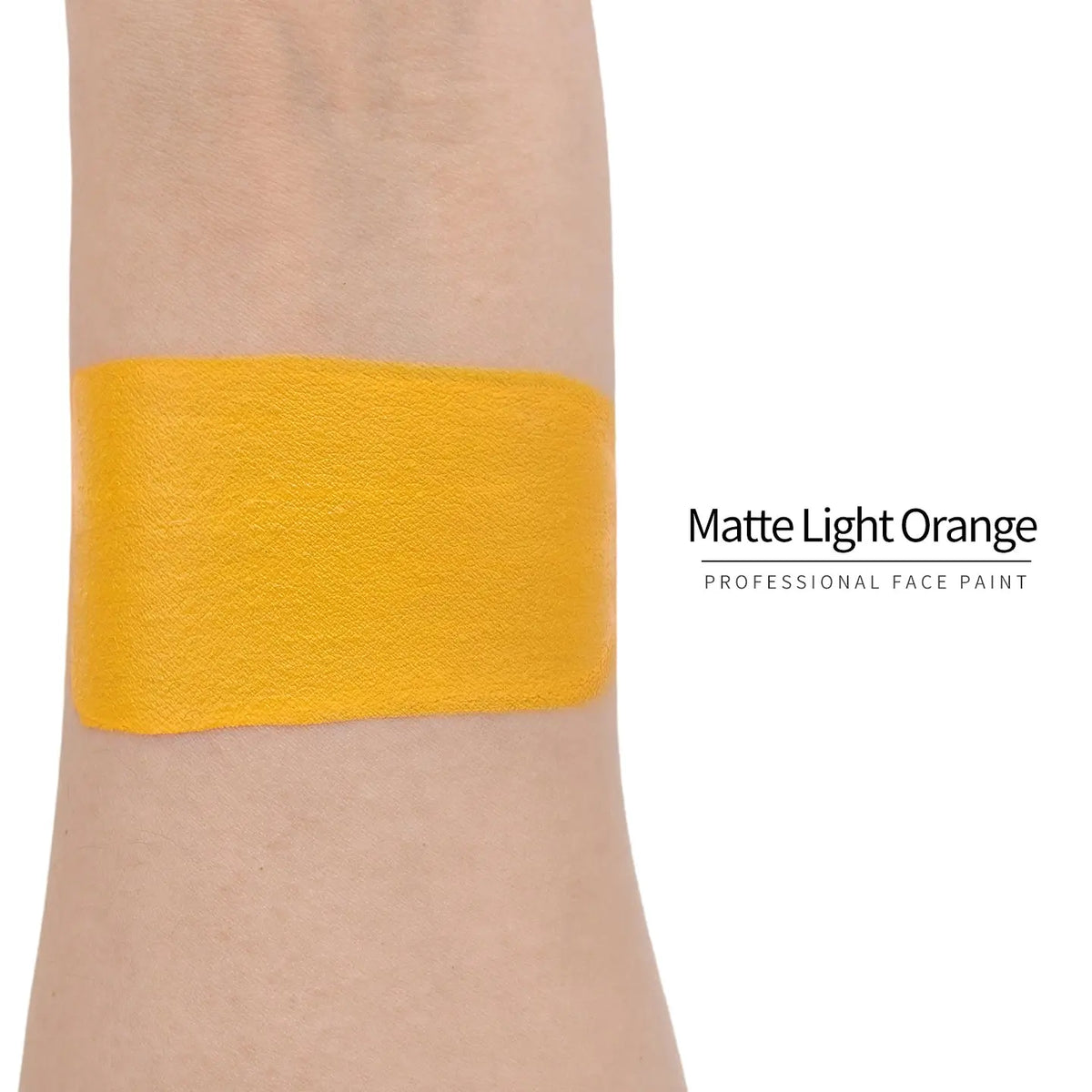 Matte light orange face paint swatch on arm, high pigment water based body art makeup