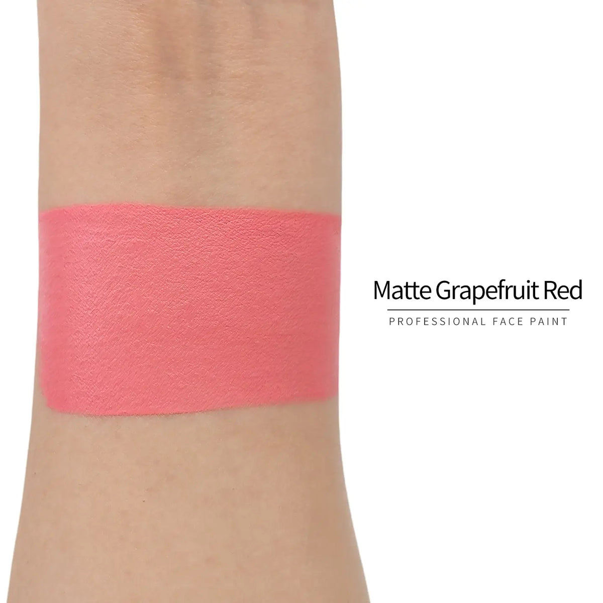 Matte grapefruit red face paint swatch on arm, high pigment water based body art makeup
