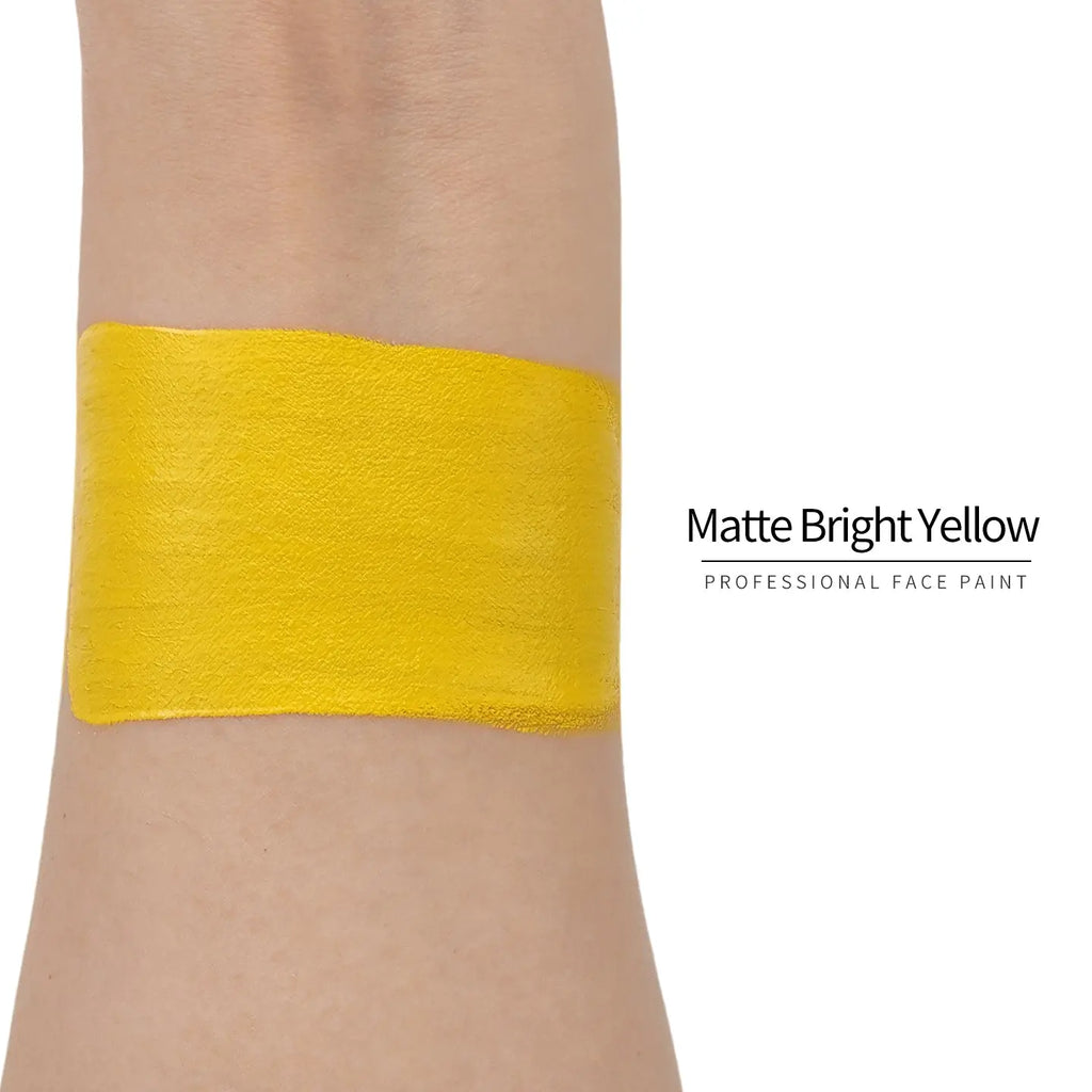 Matte bright yellow face paint swatch on arm, high pigment water based body art makeup