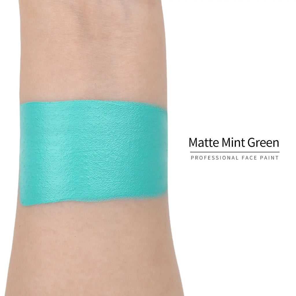 Matte mint green face paint swatch on arm, high pigment water based body art makeup