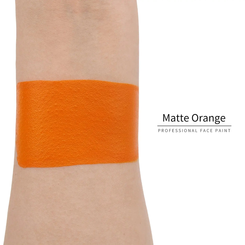 Matte orange face paint swatch on arm, high pigment water based body art makeup