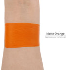 Matte orange face paint swatch on arm, high pigment water based body art makeup