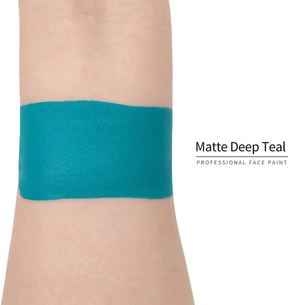 Matte deep teal face paint swatch on arm, high pigment water based body art makeup
