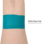 Matte deep teal face paint swatch on arm, high pigment water based body art makeup
