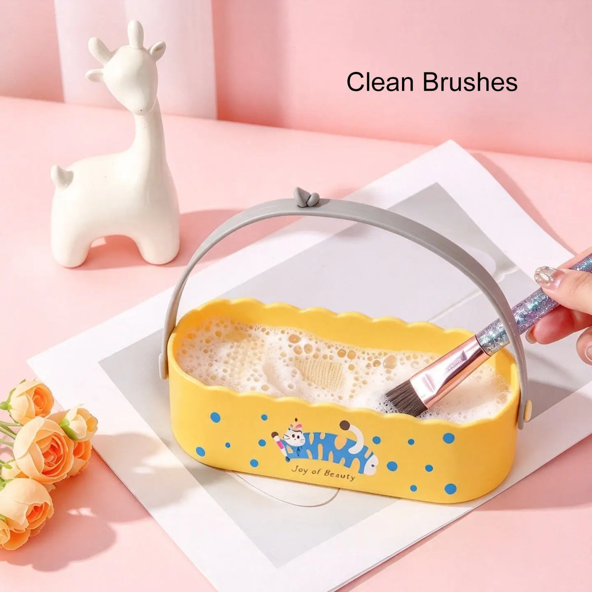 Yellow Anka Bella silicone makeup brush washer with soapy water, washing makeup brush